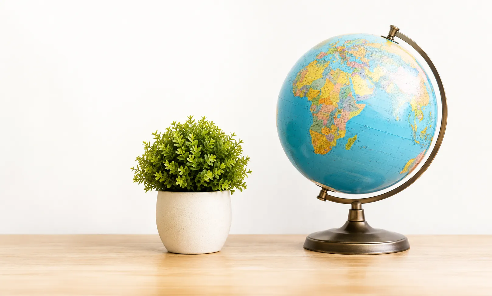 Desk globe and potted green plant